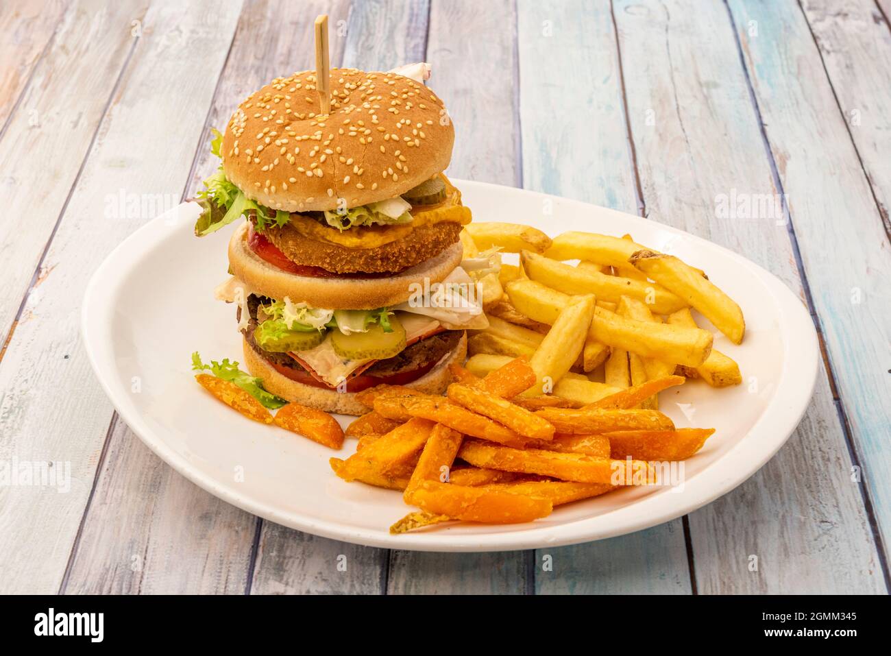 Spectacular doubledecker burger with crispy beef and chicken, lettuce