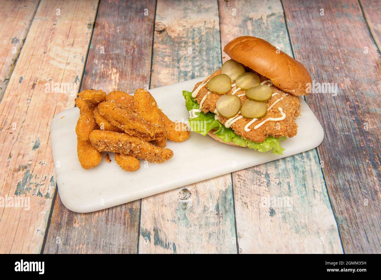 Crispy chicken burger with pickles, mayonnaise and lettuce with