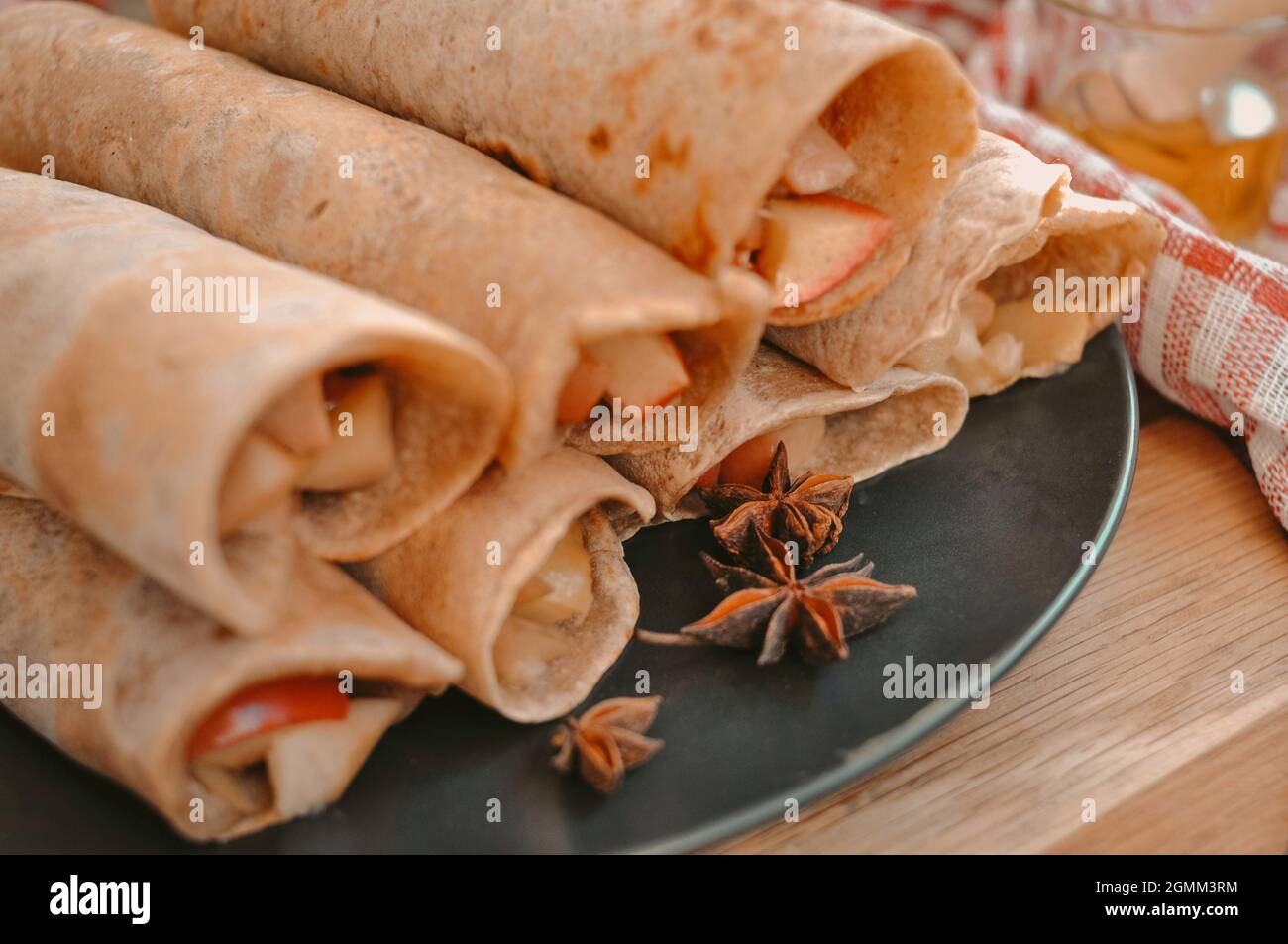 Rolled pancakes with apple cinnamon and honey  Stock Photo