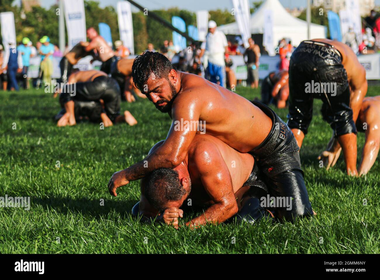 Oil wrestlers wrestle during the traditional Ulugazi Oil Wrestling