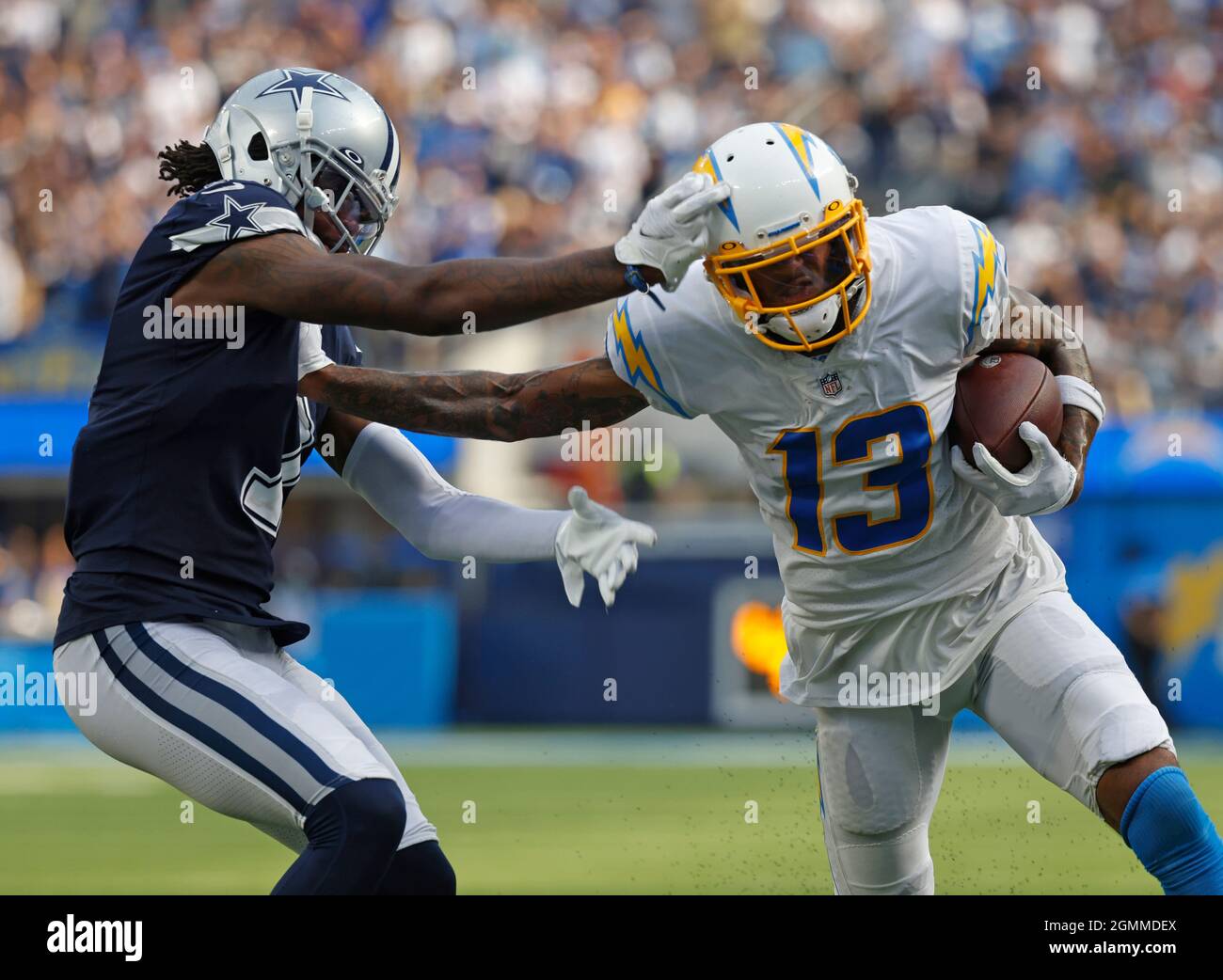 Inglewood, California, USA. 19th Sep, 2021. Los Angeles Chargers wide  receiver Keenan Allen (13) carries the ball as Dallas Cowboys corner back  Trevon Diggs (7) makes the tackle during the NFL football