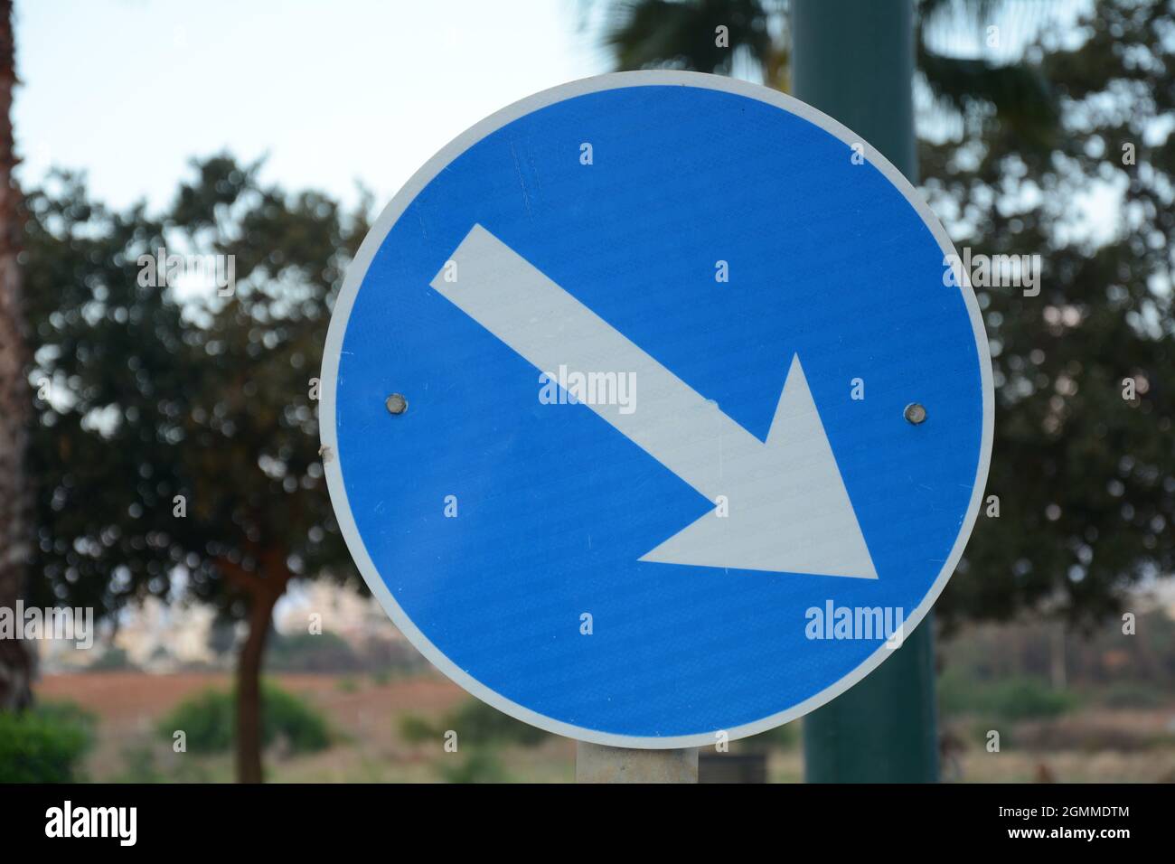Pass designated place on right. Blue road sign Pass on This Side with white arrow pointing to the right. Mandatory signs. Road signs in Israel Stock Photo