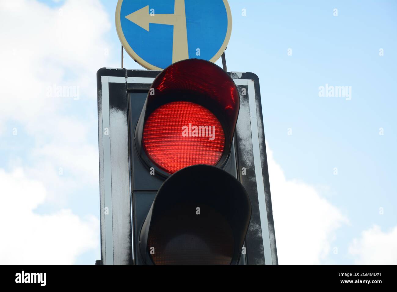 Red traffic light and Go straight or left sign. Mandatory signs. Road signs  in Israel Stock Photo - Alamy