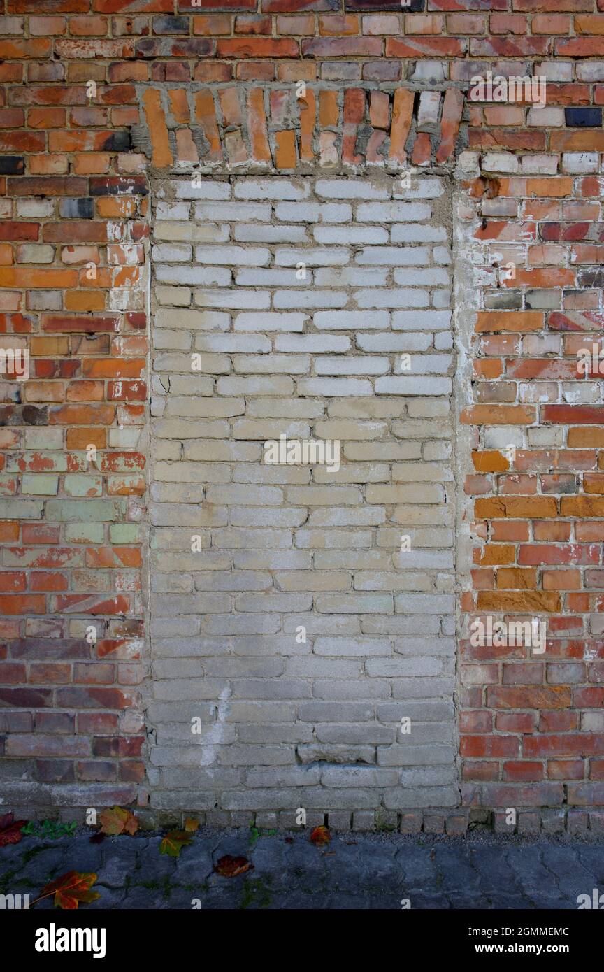 Doorway in a brick wall closed  with white silicates Stock Photo