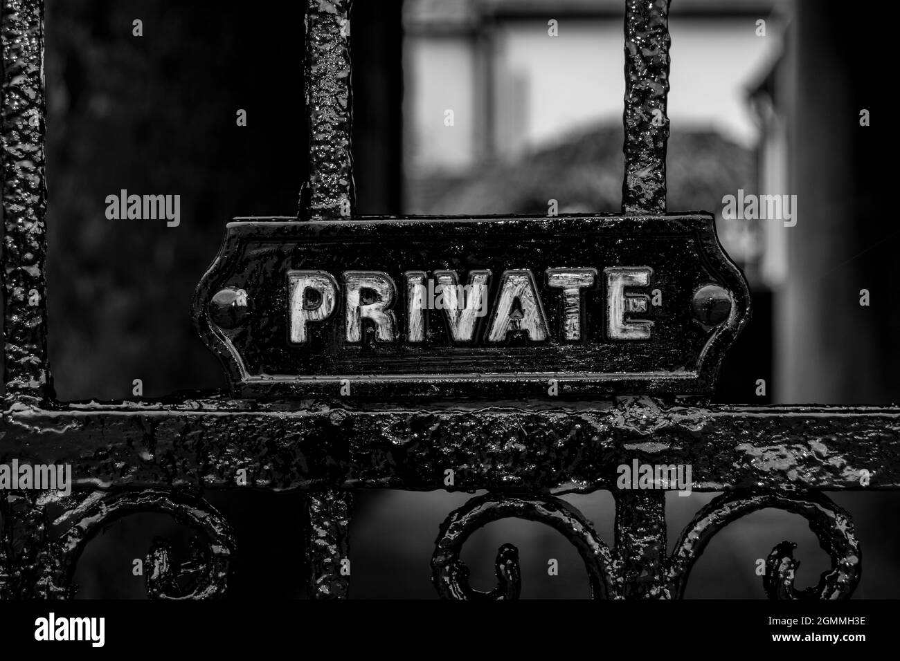 Private signage on a black metal ornamental gate Stock Photo