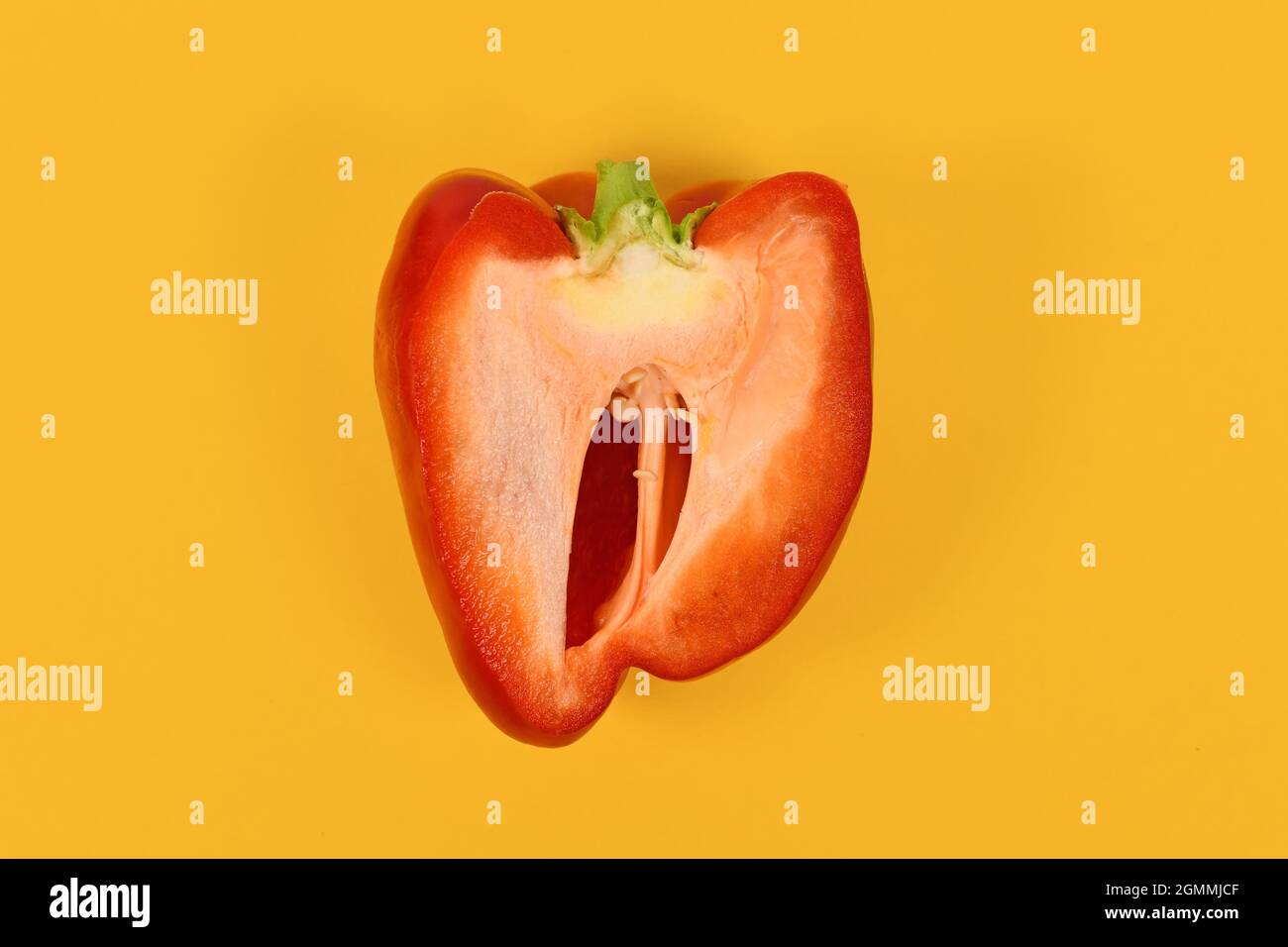 Red bell pepper cat open on yellow background Stock Photo Alamy