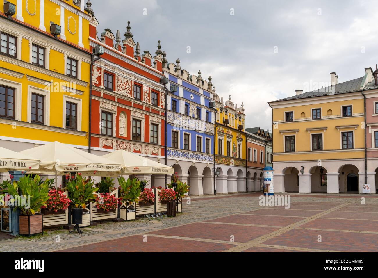 Zamosc, Poland - 13 September, 2021: colorful Renaissance buildings and street restaurant on the Great Market Square in the old city center of Zamosc Stock Photo