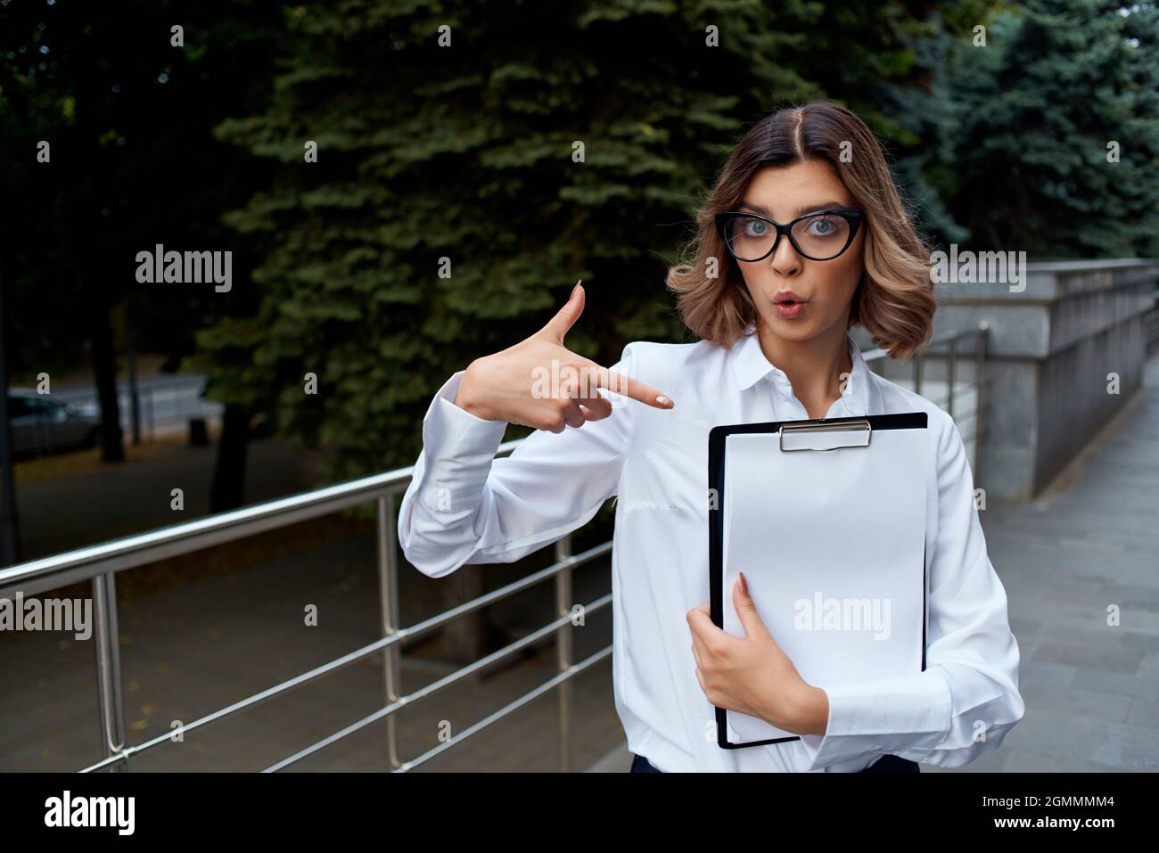 Business woman in white shirt on the street with work documents Stock ...