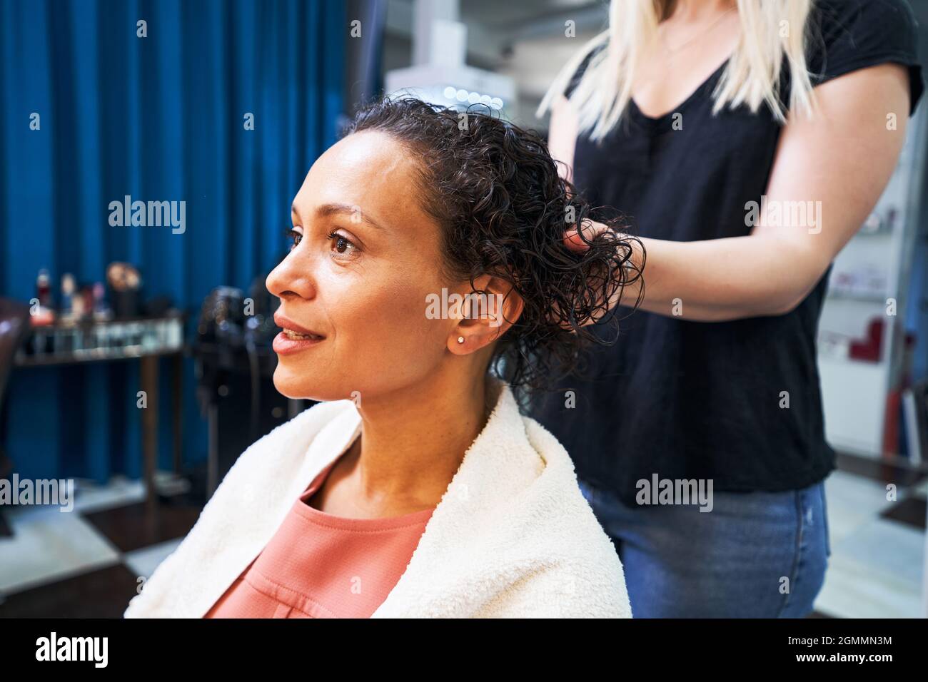 Blonde beauty master doing spa hair treatment Stock Photo