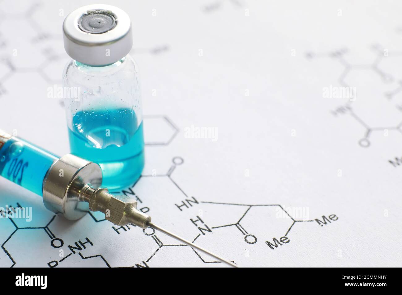 small jars with injection and syringe for injection on blue background ...