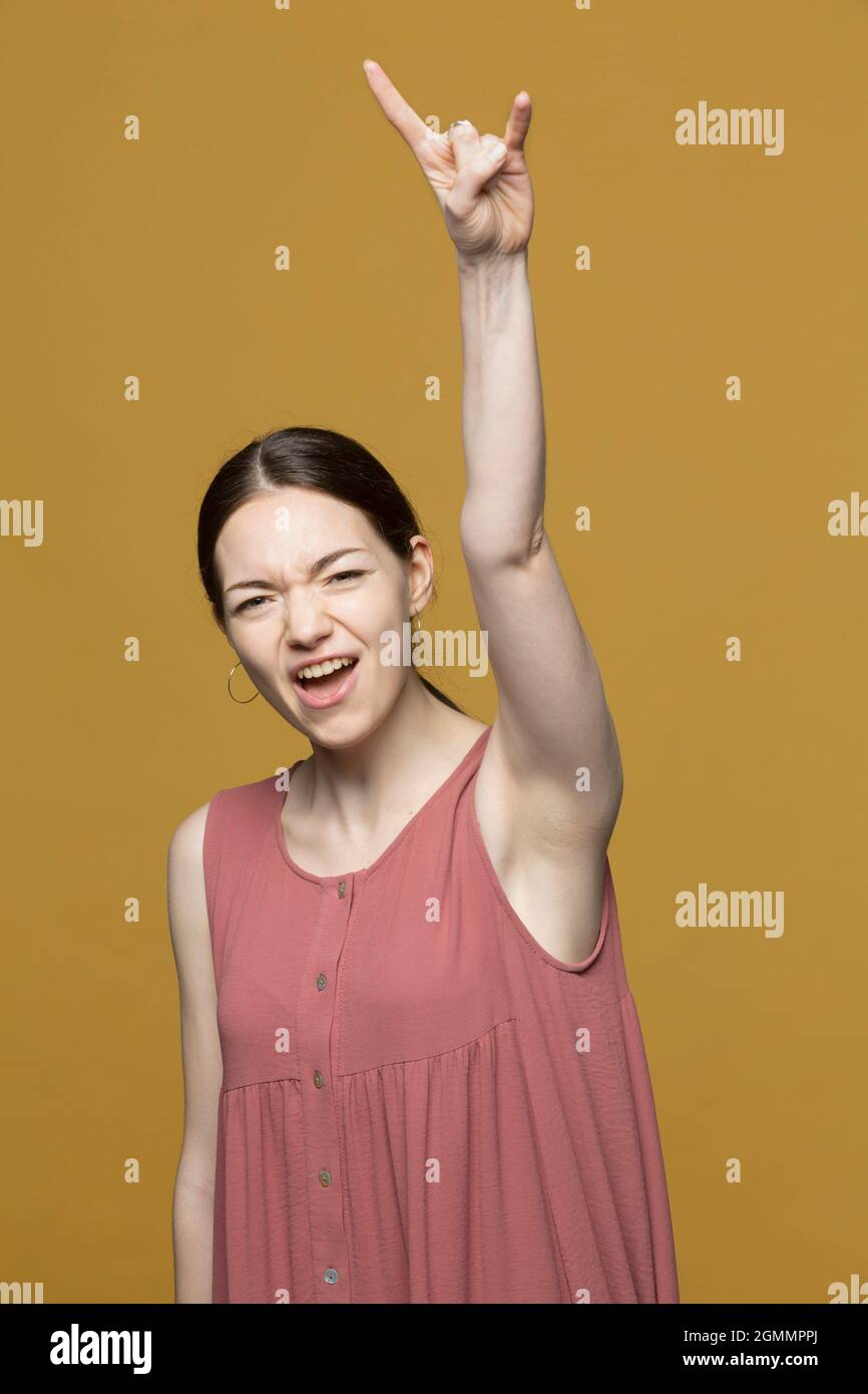 Portrait excited young woman cheering Stock Photo