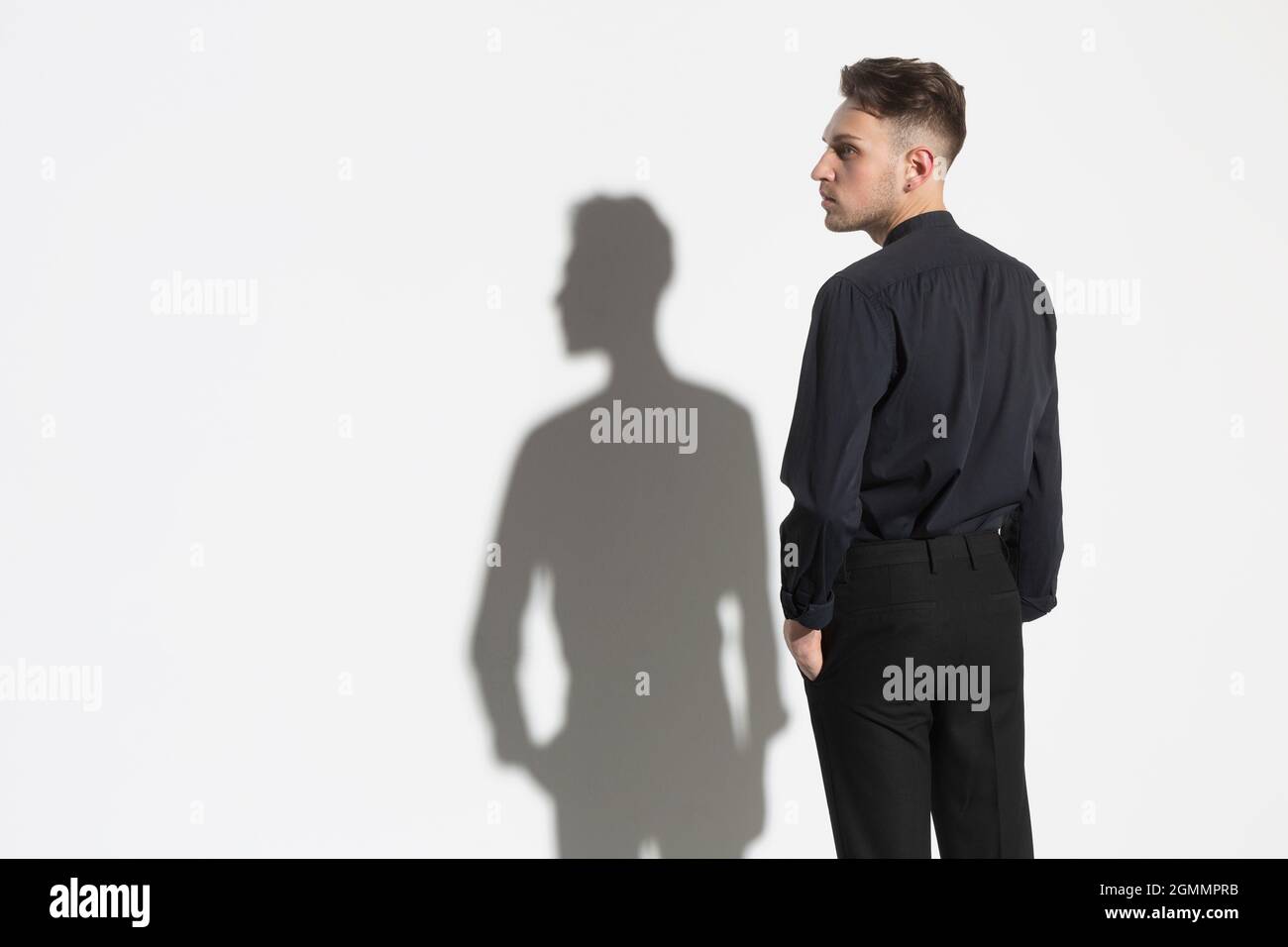 Portrait man and shadow at white wall Stock Photo