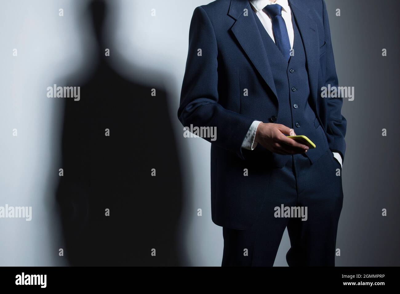 Businessman in suit holding smart phone Stock Photo