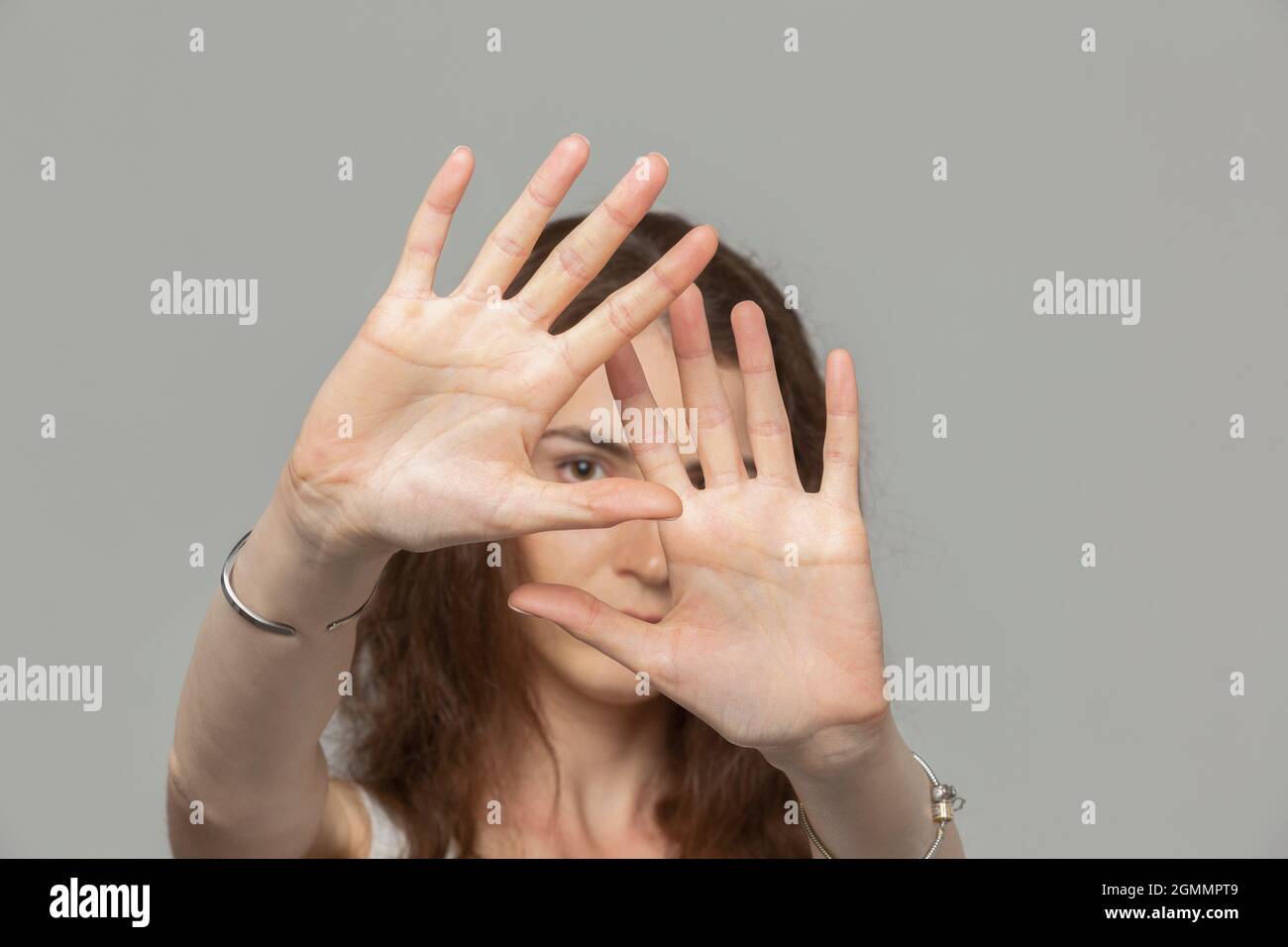 Portrait woman covering face with hands Stock Photo