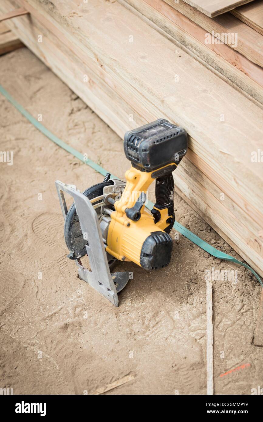 Power saw leaning against wood board Stock Photo Alamy