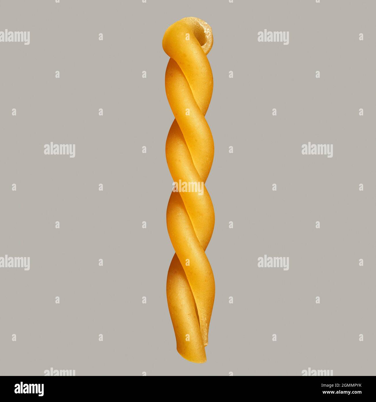 Close up uncooked gemelli pasta noodle on gray background Stock Photo