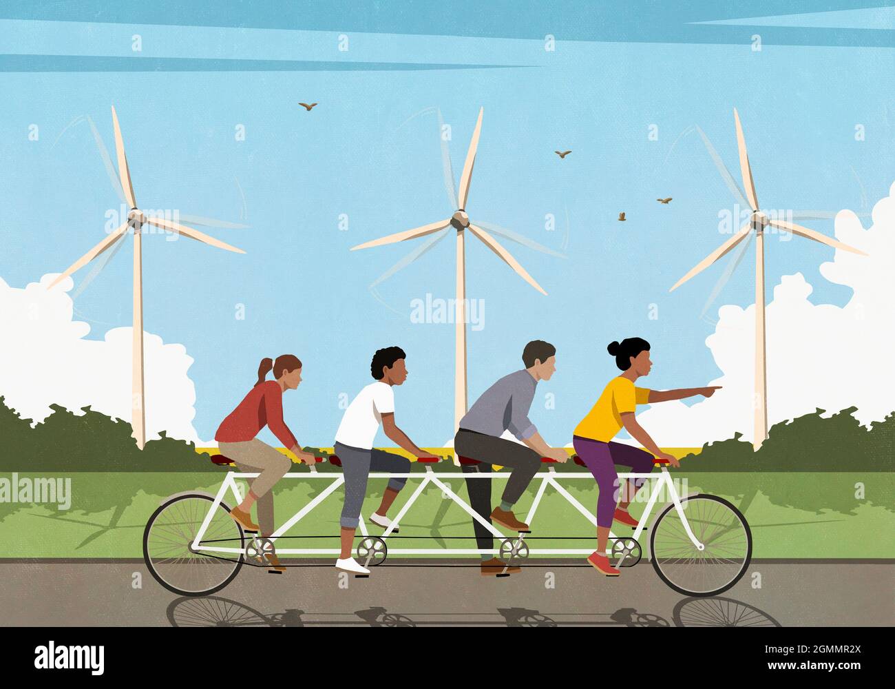 Friends riding tandem bicycle along idyllic field with wind turbines Stock Photo