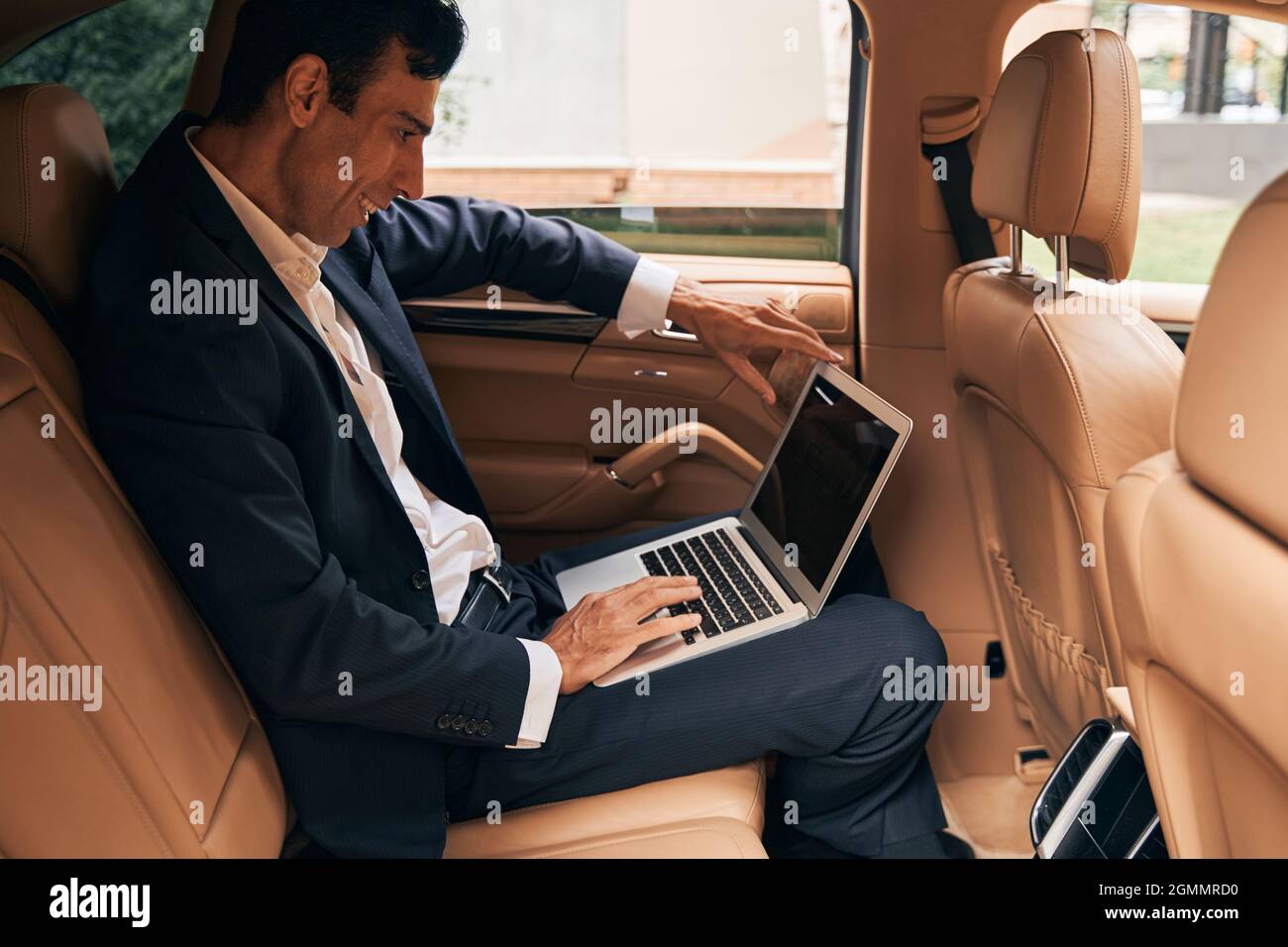 Business specialist using laptop on car passenger seat Stock Photo Alamy