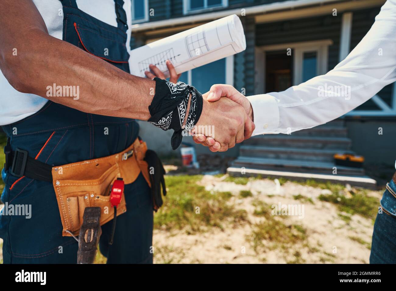 Engineers agreeing on construction plan with handshake Stock Photo