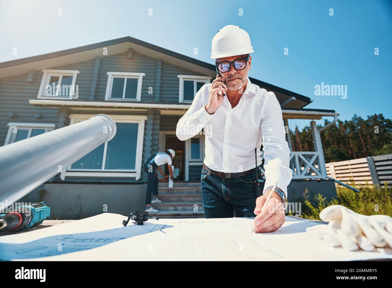 Concentrated housebuilder making notes on house layout Stock Photo