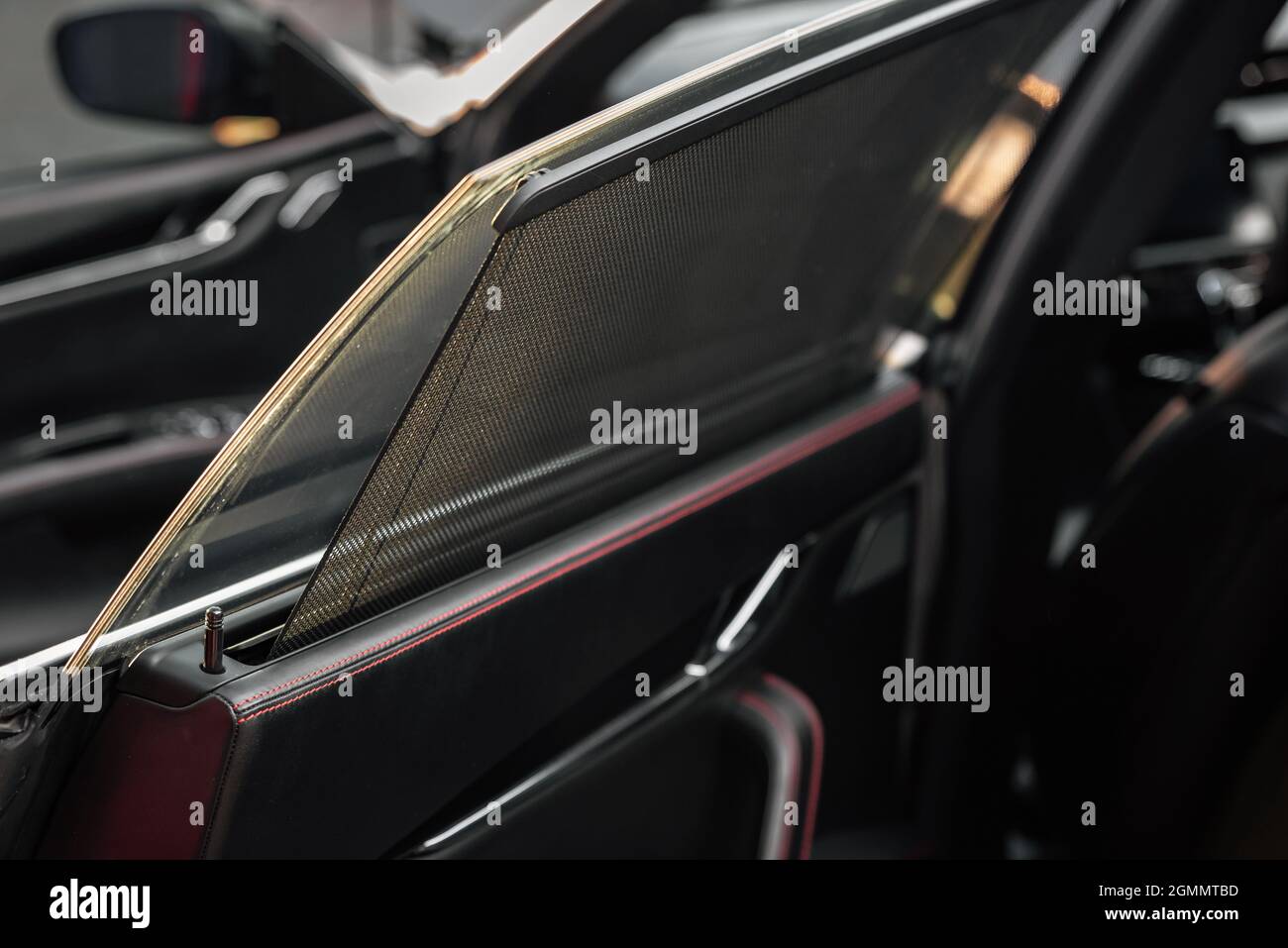 Car rear window side curtain. Sunblind curtain in a modern luxury car