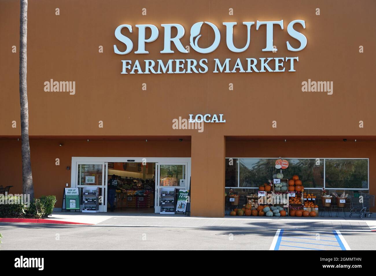 Sprouts neighborhood farmers market grocery store front and logo in