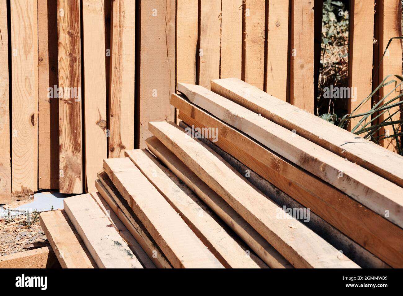 Stack of sawed wooden planks or timber at a construction site. Stock Photo