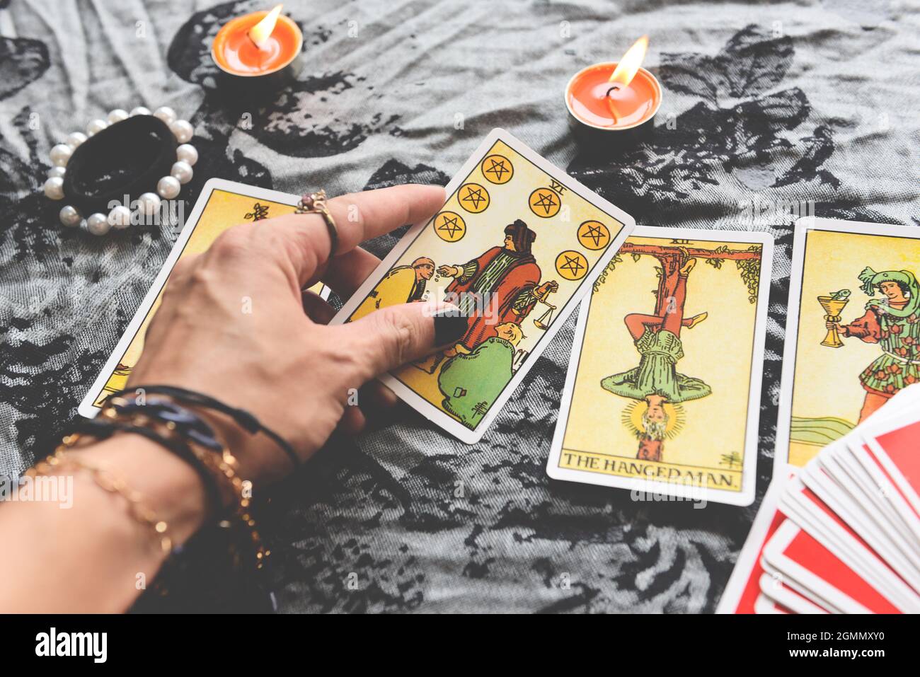 Show fortune tellers of hands holding tarot cards and tarot reader with candle light on the table, Performing readings magical performances, Things my Stock Photo