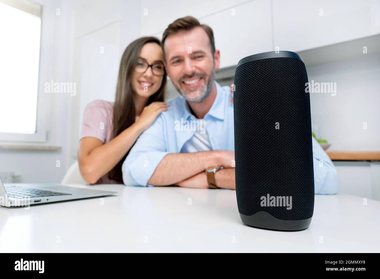 Couple using smart speaker, smart home system appliance, modern assistant Stock Photo
