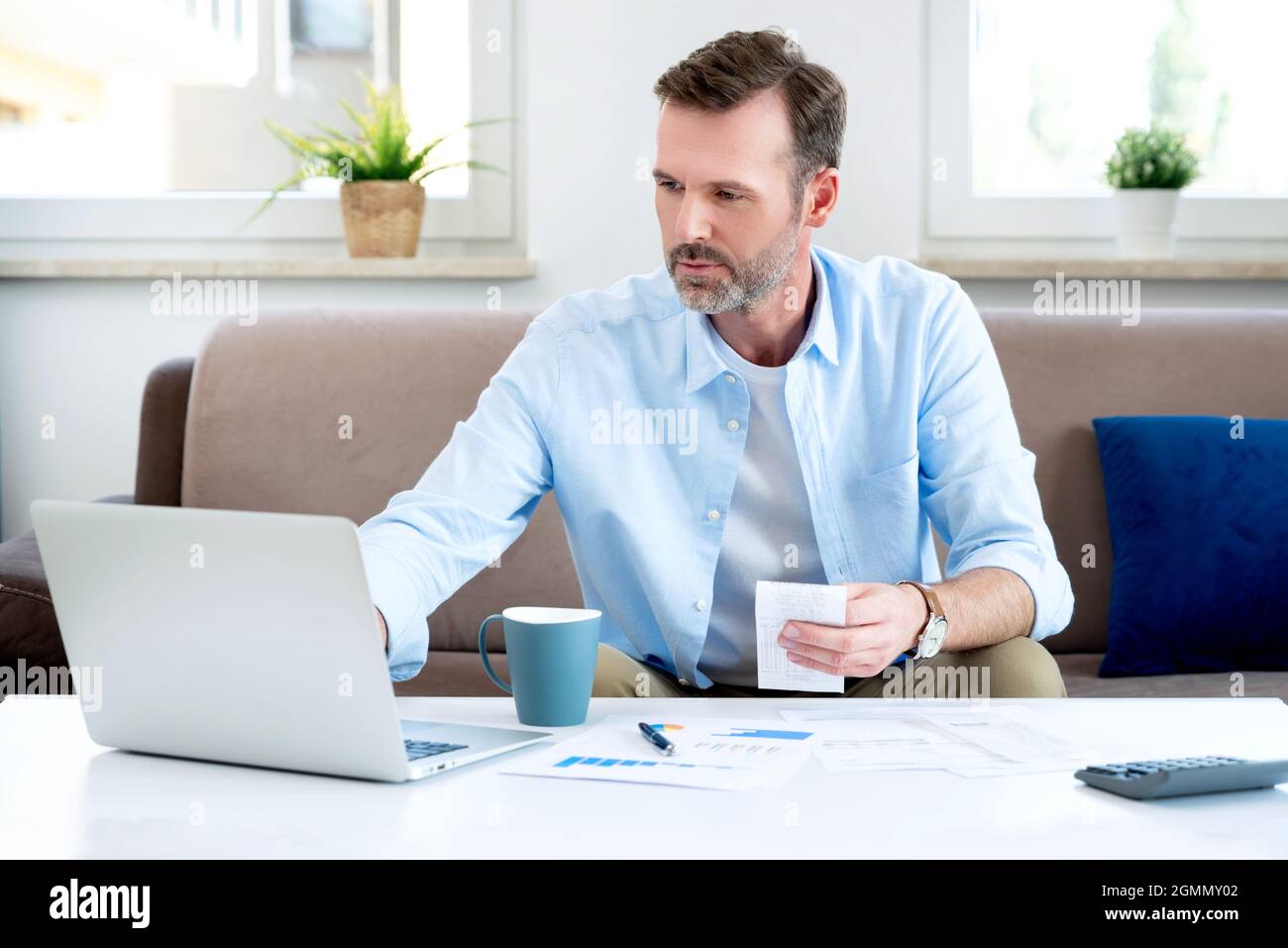 Man sitting at the table. Home budget, finances concept Stock Photo