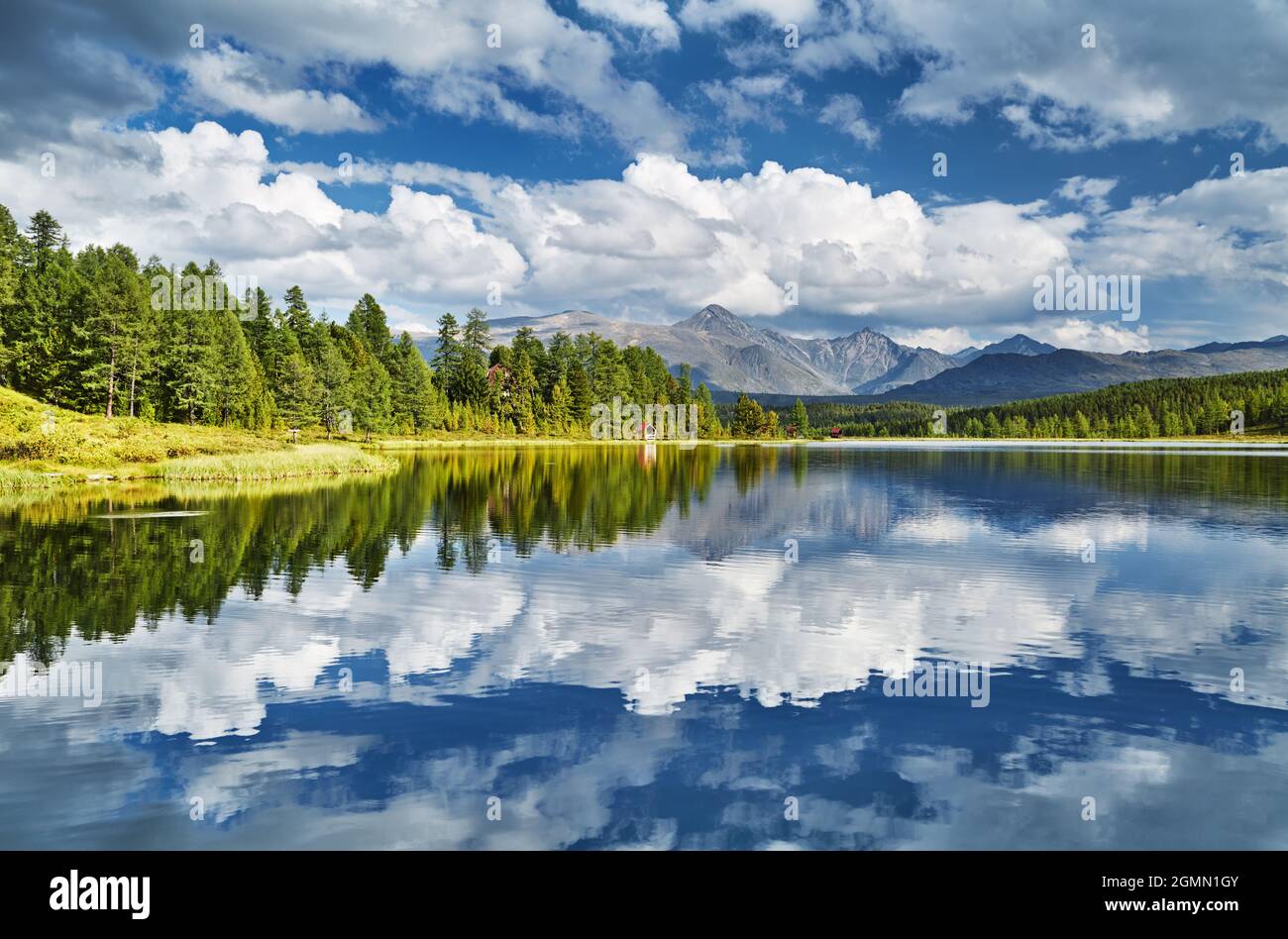 Beautiful mountain lake, still water, forest and reflection Stock Photo
