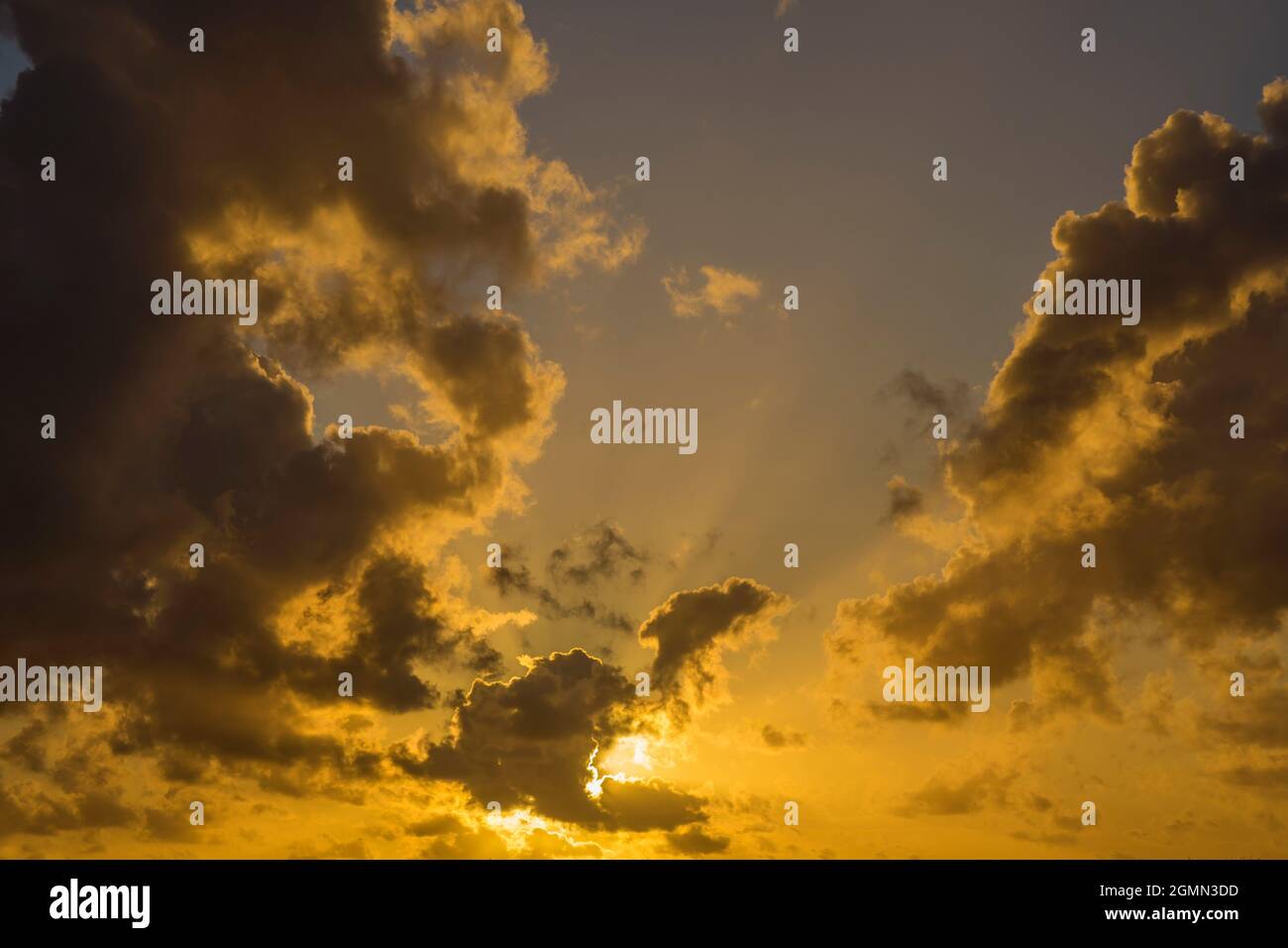 Golden sunset sky with clouds and sunrays as background Stock Photo - Alamy