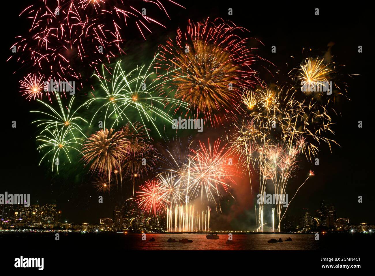 Colorful fireworks celebration and the city night light background. Fireworks festival. Stock Photo