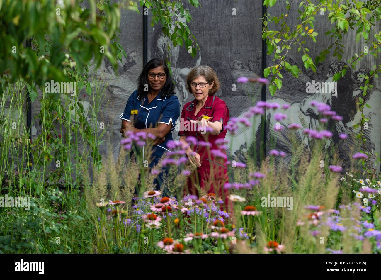 London, UK.  20 September 2021. Modern day nurses at The Florence Nightingale Garden, by Robert Myers, at the RHS Chelsea Flower Show. Cancelled due to Covid-19 concerns last year, this is the first time that the show has been held in September (usually May).  The show runs to 26 September at the Royal Hospital Chelsea.  Credit: Stephen Chung / Alamy Live News Stock Photo