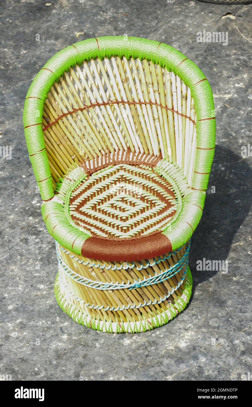 Selective focus on BAMBOO CHAIR in morning sun light. Stylish bamboo chair structure with red and green rope. Handmade indian craft. Comfortable seat Stock Photo Alamy