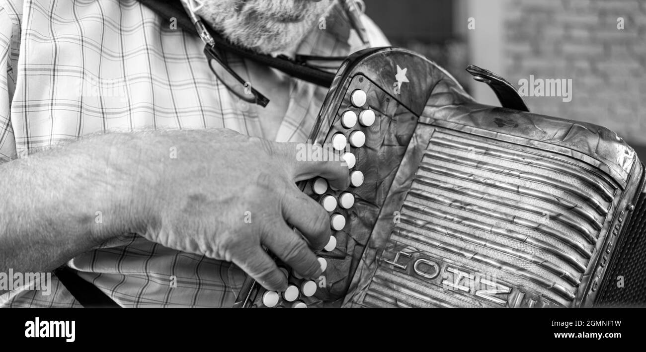 OLZA, ITALY - Aug 29, 2021: Francesco Bonomini, a traditional organ harmonica player. Stock Photo