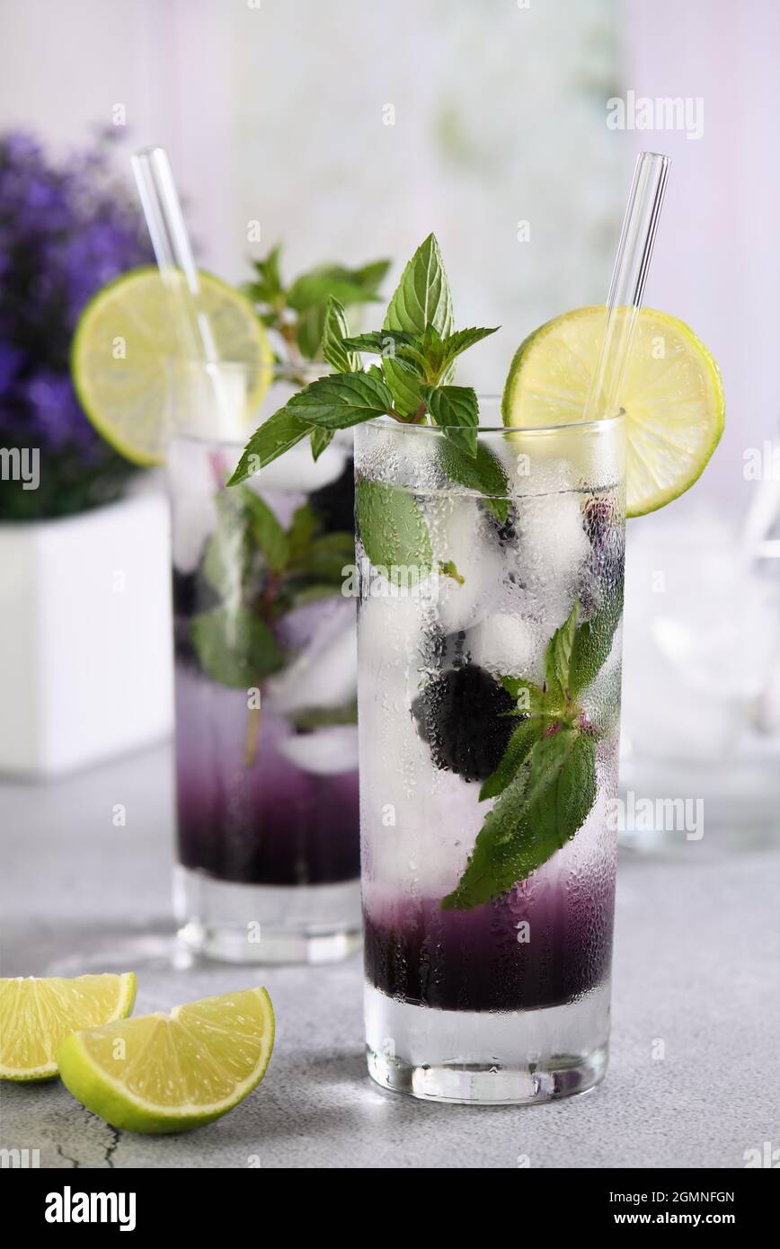 Cold refreshment organic non-alcohol cocktail Blackberry mojito with berry fruit in glass Stock Photo