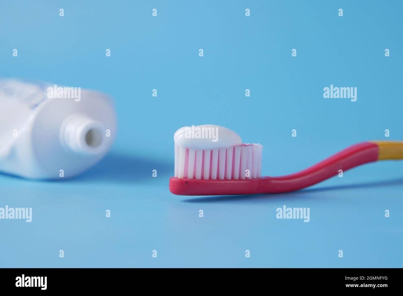 tooth brush with paste on blue background  Stock Photo
