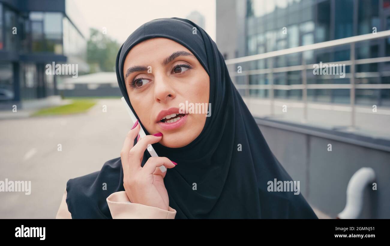 Young arabic woman in hijab having phone call outside Stock Photo - Alamy