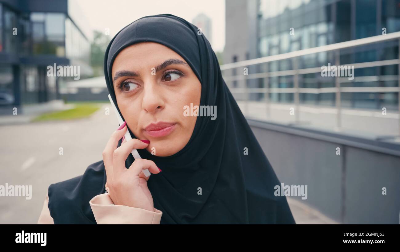 Arabian woman in hijab having phone call outside Stock Photo - Alamy