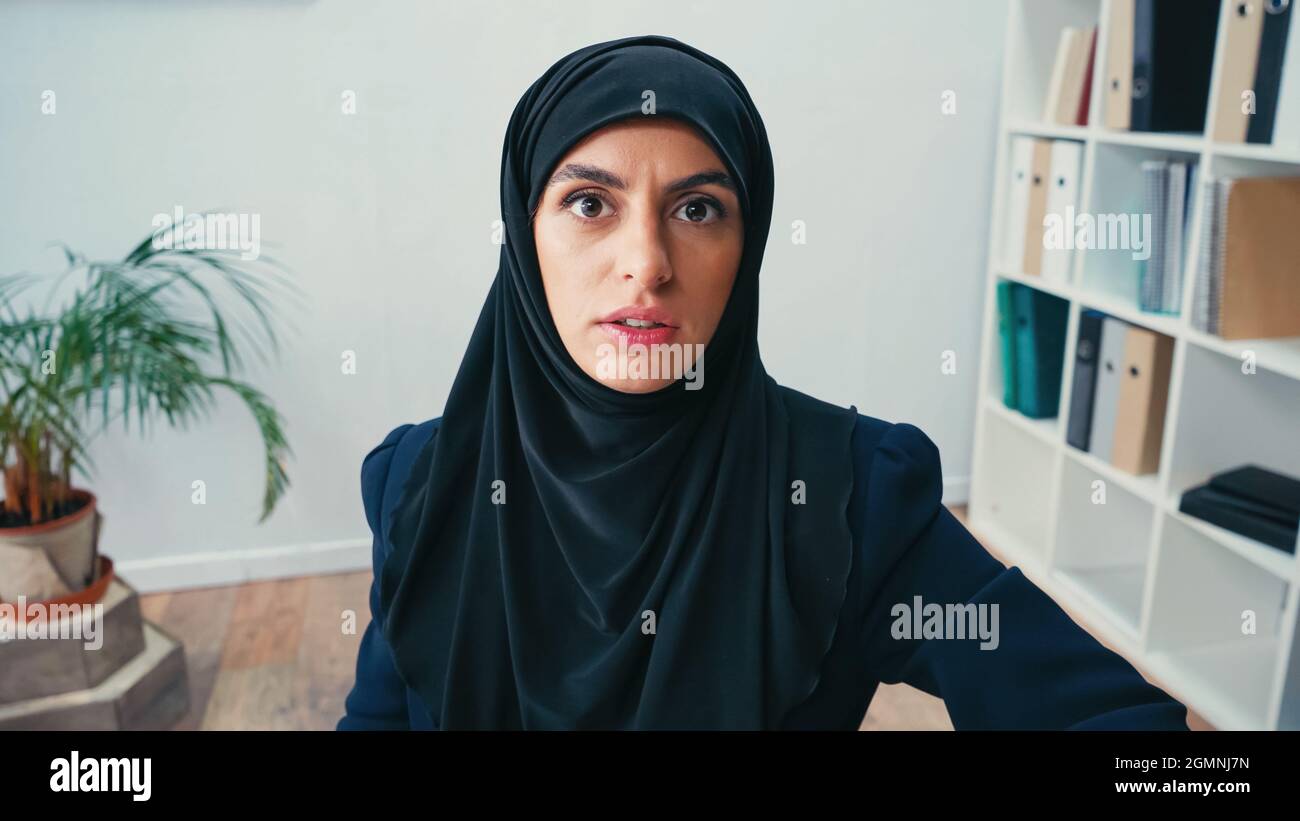 muslim businesswoman in hijab looking at camera Stock Photo