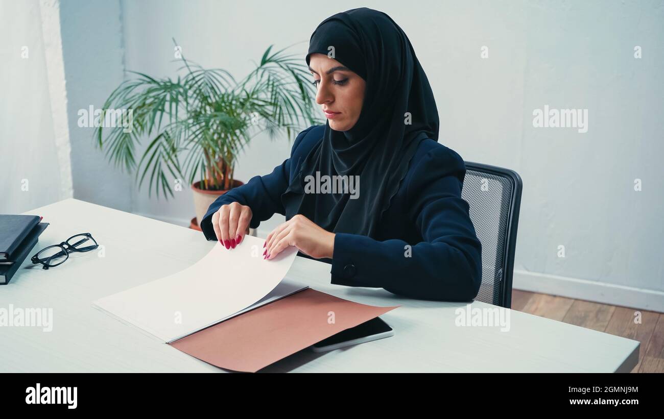 Muslim businesswoman in hijab working with documents in office Stock ...