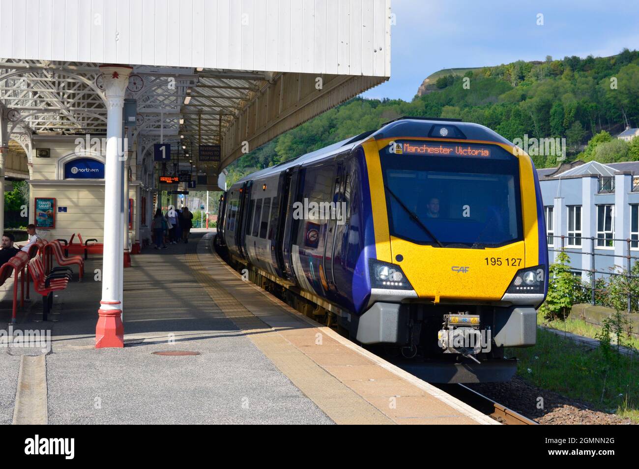 HALIFAX. WEST YORKSHIRE. ENGLAND. 05-29-21. The railway station. Northern Rail DMU 195127 at the platform with a train for Manchester Victoria. Stock Photo