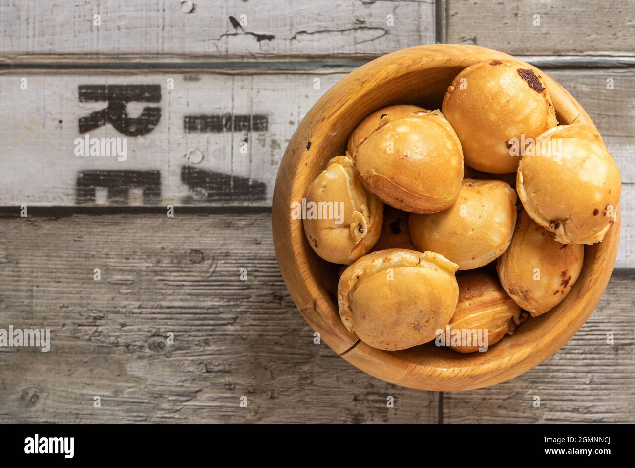 Kaya ball in a wooden bowl placed on a wooden background Stock Photo