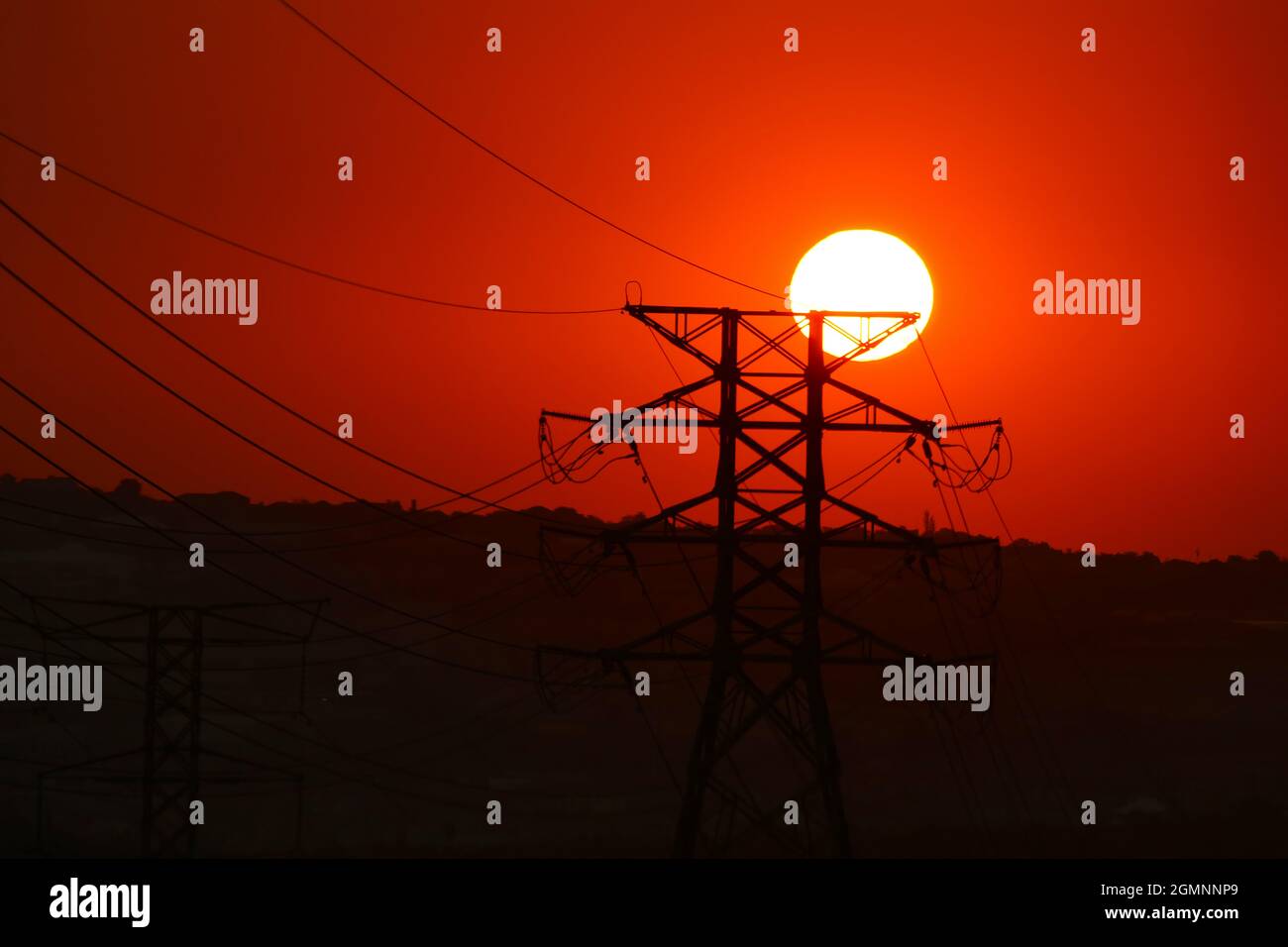 electricity poles under the sunset Stock Photo - Alamy
