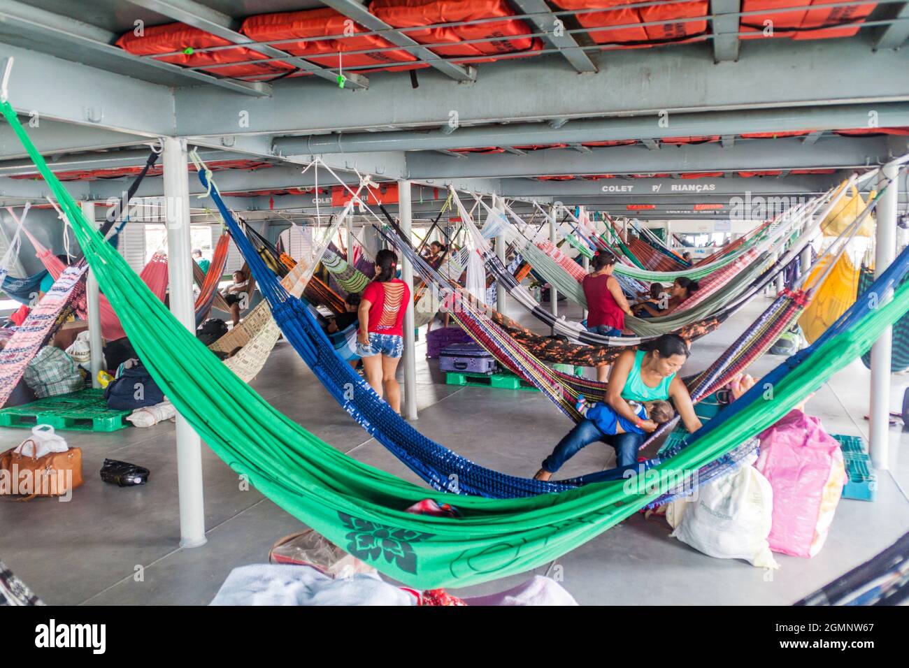 TABATINGA, BRAZIL - JUNE 22, 2015: Passengers of hammock deck at the boat Diamante which plies river Amazon between Tabatinga and Manaus, Brazil. Stock Photo