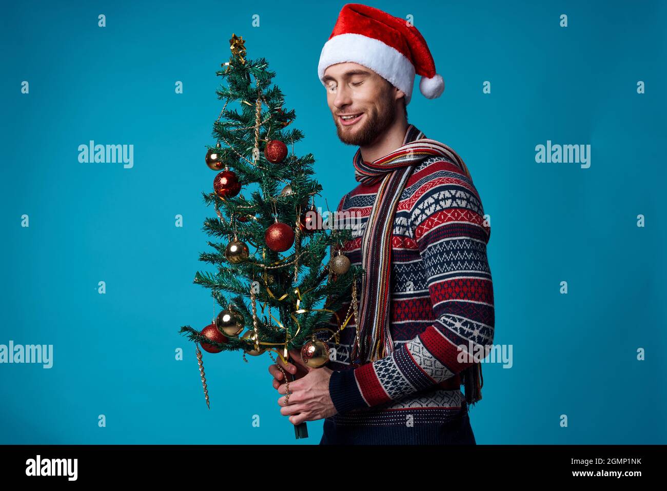 Cheerful man in a santa hat holding a banner holiday isolated ...