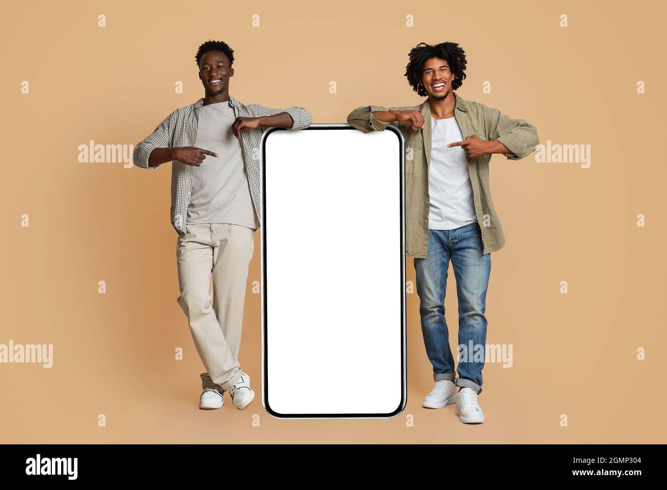 Mobile Ad. Two Black Guys Pointing At Big Smartphone With White Screen Stock Photo