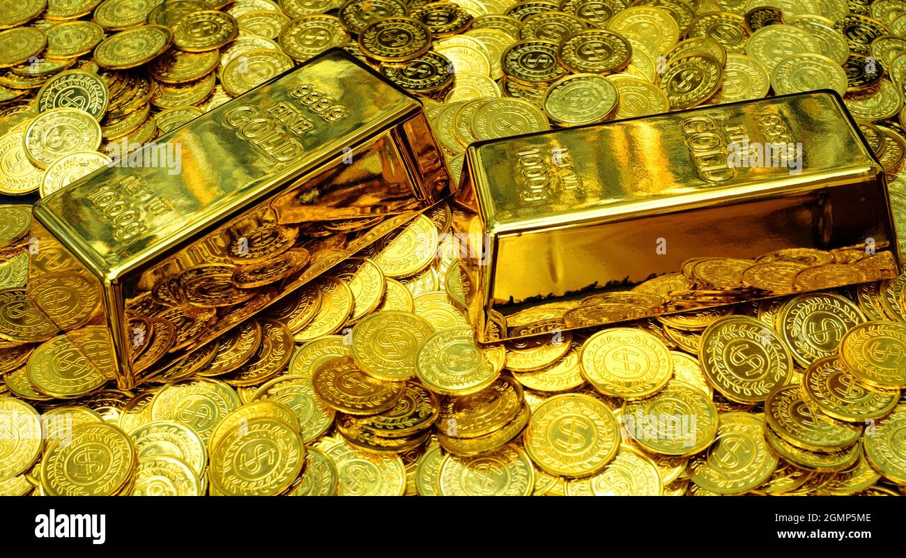 Gold bullion on pile golden coins a lot of Stock Photo Alamy