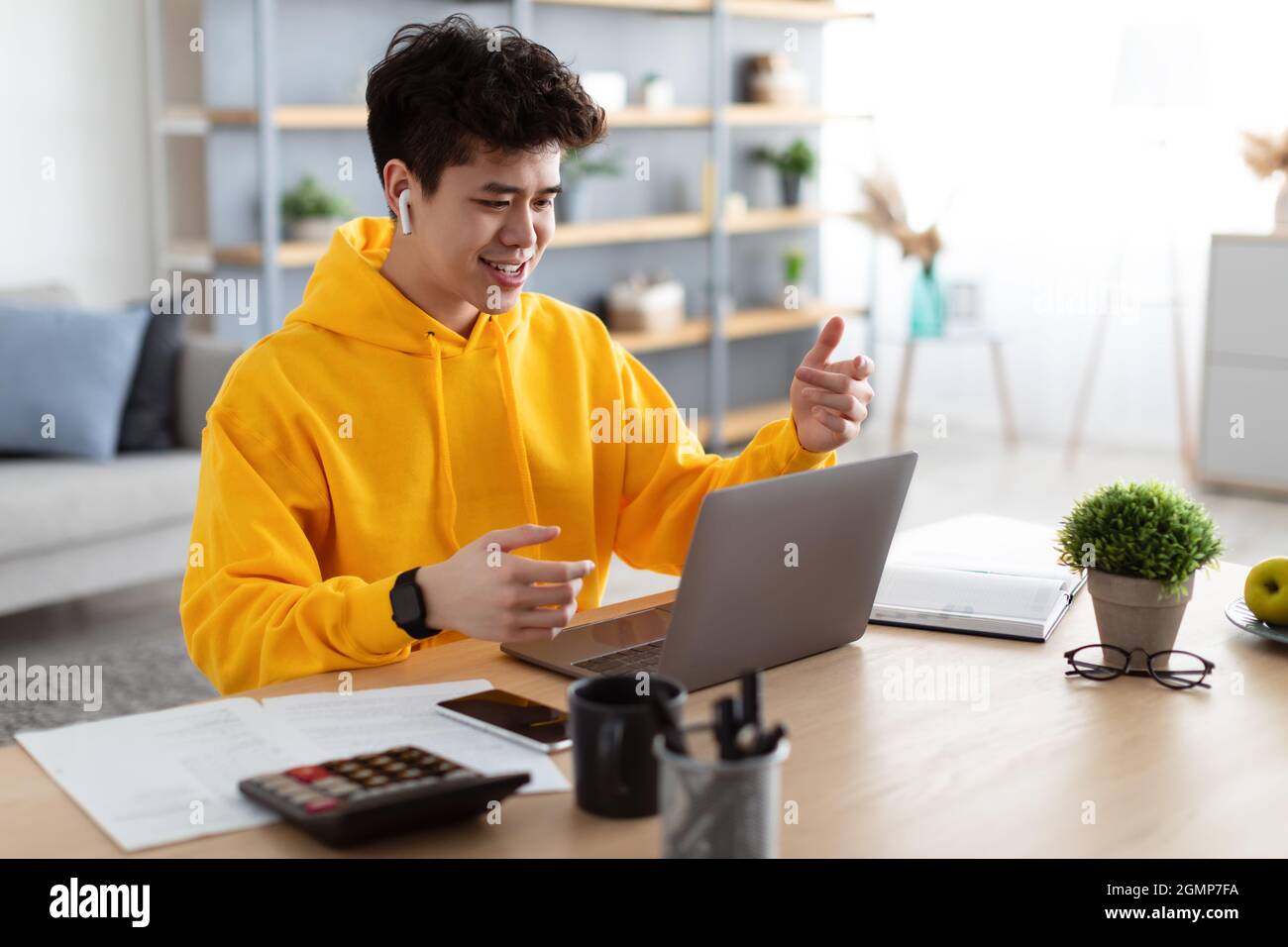 Asian man having video call using laptop and talking Stock Photo